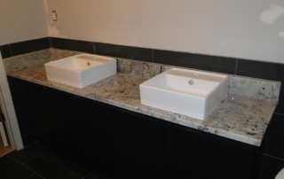 dual porcelain sinks with white granite vanity top