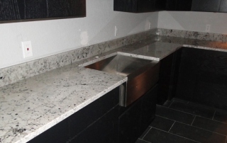 custom modern kitchen with white and black granite countertops